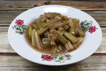 Traditional stirred and fried cutting fresh lotus stem seasoning with soy sauce and pepper on the plate. Famous vegetarian side dish menu in Asia restaurant. High fiber and nutrition. 