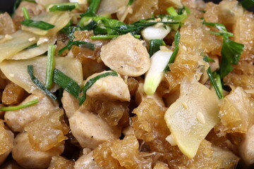 Traditional fried and stirred cutting pork skin with pork meat ball and chopped spring onion in Chinese style. Famous luxury ancient menu in Asia restaurant. 