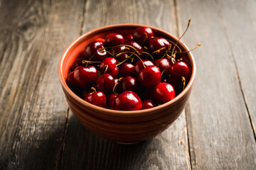 Freshly harvested cherries bowl. Selective focus. Shallow depth of field.