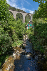 Spectacular view of an old house in front of the old railway bridge at the Ravenna gorge viaduct in Breitnau, Germany