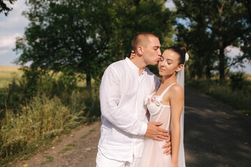 Portrait of groom and bride in their wedding day. Summer wedding