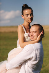 Newlyweds walking in field. Groom hug bride after wedding ceremony