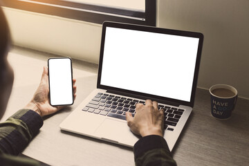 computer,cell phone mockup image.hand woman work using laptop texting mobile.blank screen with white background for advertising,contact business search information on desk in cafe.marketing,design