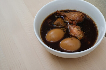 stewed eggs or eggs and chicken with spices in brown sauce traditional Thai food