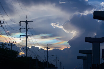 Cloud iridescence or rainbow cloud at sunset over Bangkok city, Thailand.
