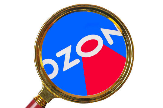 parcel delivery of OZON online store. Ozon is- text under a magnifying glass, isolated on white background.