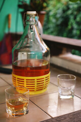 a bottle of homemade wine on the table on the terrace