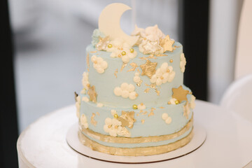 Candy bar. Blue decorated cake standing of festive table with deserts