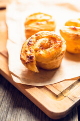 Fresh sweet bun with orange jam on the rustic wooden background. Selective focus.
