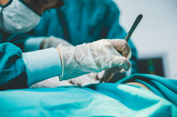 Medical team of surgeons in hospital doing invasive surgical interventions. Surgery operating room...
