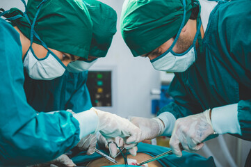 Medical team of surgeons in hospital doing invasive surgical interventions. Surgery operating room with electrocautery equipment for cardiovascular emergency surgery center.