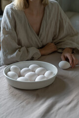 Woman cooking on kitchen. Diet, healthy, organic food cooking - female chef holds in hands eggs.