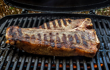 Medium t-bone steak on barbecue grill