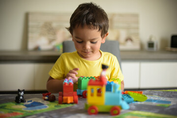young boy playing home with blocks