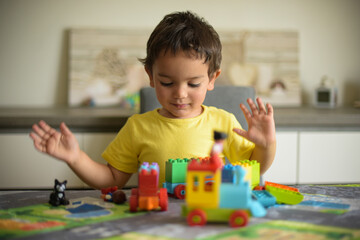 young boy playing home with blocks