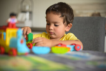 young boy playing home with blocks