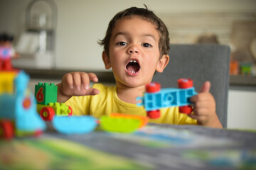 young boy playing home with blocks