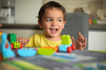 young boy playing home with blocks