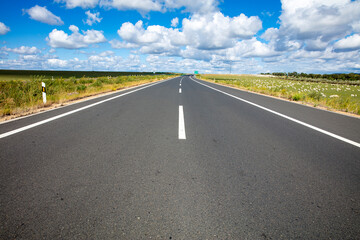 Empty highway, blue sky and white clouds landscape