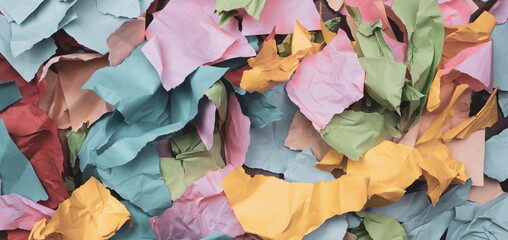  torn and crumpled color papers on a table