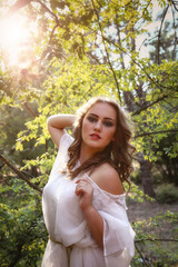 Naklejka premium Beautiful mystery gothic woman in long white dress in autumn forest.