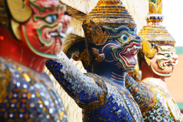 colorful tradition demon statue which support golden pagoda - obrazy, fototapety, plakaty