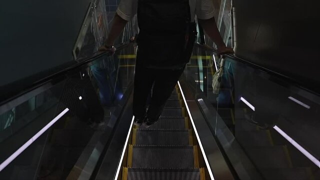 A boy plays dangerously on escalators