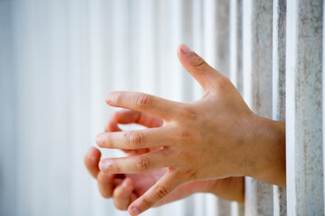 close up of prisoner hand in jail