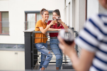 Friends having home party on balcony