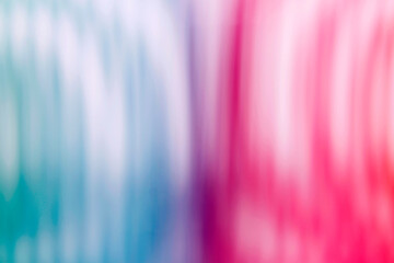 Blurred background of several bright colors: blue, purple, red