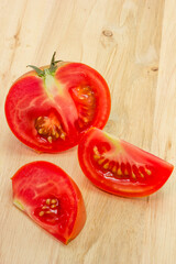 Red tomato slices on chopping board