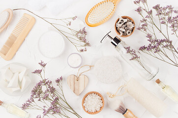 Elegant light natural bath accessories and beauty products for hygiene and body care with lavender twigs, heart on white background, flat lay.