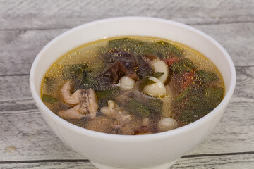 Thai style soup with meat and mushrooms