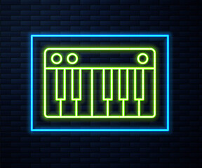 Fototapeta premium Glowing neon line Music synthesizer icon isolated on brick wall background. Electronic piano. Vector Illustration.