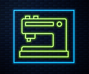 Glowing neon line Sewing machine icon isolated on brick wall background. Vector Illustration.