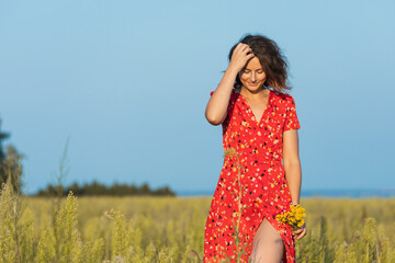 beautiful woman laughs and dances outdoors in a meadow during sunset.  Livestyle walking concept..