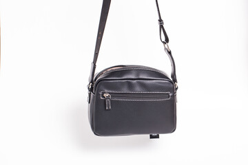 Black women`s leather bag on a white background.
