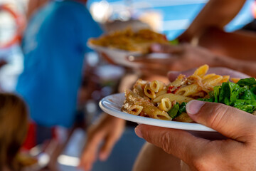 Buffet plate of pennes pasta on a tour yacht 