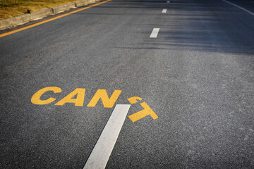 CAN&rsquo;T word without &rsquo;T on black asphalt road surface with sunlight, business challenge concept and overcome success idea