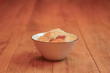 Cake Napoleon of puff pastry with sour cream in a bowl. Tasty and nutritious dessert. Georgian...