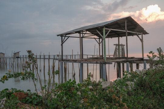 Langgai is made of bamboo and wood at Parit Jabar , Batu Pahat , Malaysia with beautiful sunrise as background. Soft focus, noise and grain due long exposure.