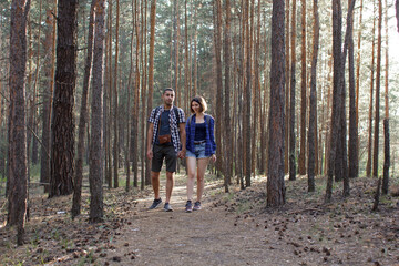 two tourists walking along a forest road