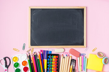 Concept Back To School Color Chalk Pencil Notebook Stationery on pink Blackboard Background. Design...