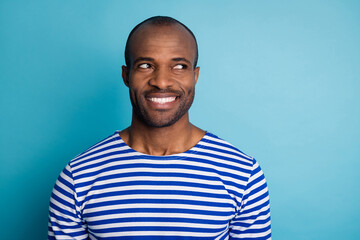 Portrait of satisfied candid afro american guy look copyspace enjoy summer holiday free time wear striped sailor vest isolated over blue color background