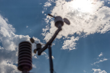 Home weather station on a background of blue sky with the sun behind the clouds. Measurement of...