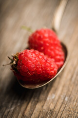 Freshly harvested raspberry on the rustic wooden background. Selective focus. Shallow depth of field.
