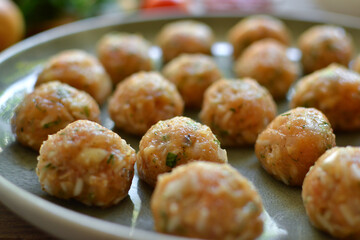 Chicken meatballs recipe. Step by step cooking. Raw chicken meatballs on a gray platter. Close up.