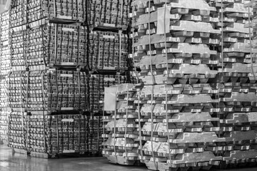 Aluminum ingot bar stacked in warehouse. Raw material for industrial concept. General cargo...