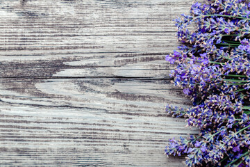 Fresh lavender flowers blossom on old rustic wooden board background with copy space for text. Flatlay french provence style lavender flower blossom. Lavender aromatherapy. Drying lavender flowers.