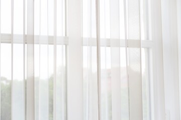 Light permeating through the white curtain at home